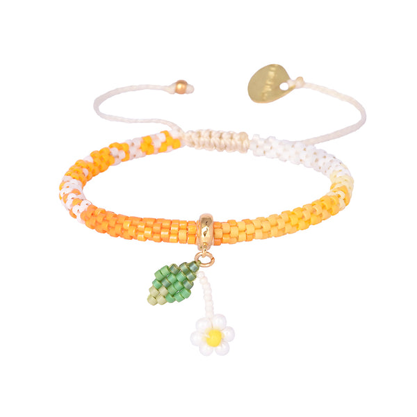 Adjustable beaded gold plated bracelet with charms