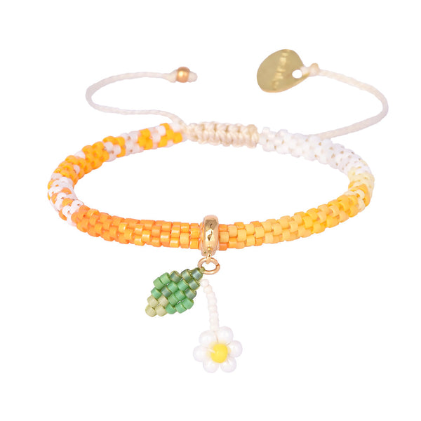 Adjustable beaded gold plated bracelet with charms